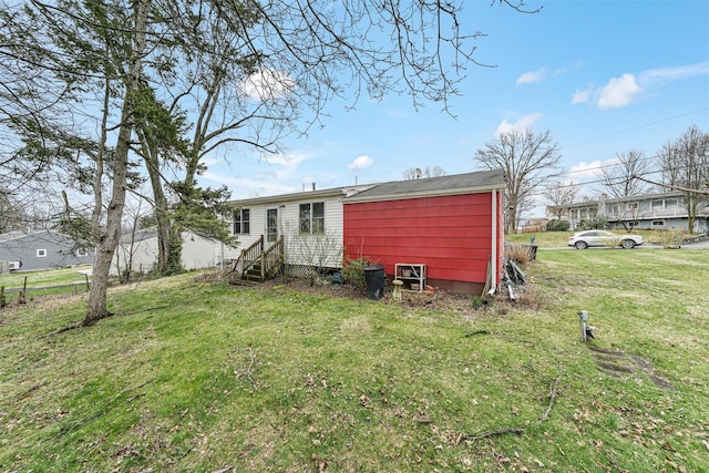 rear view of property with a yard