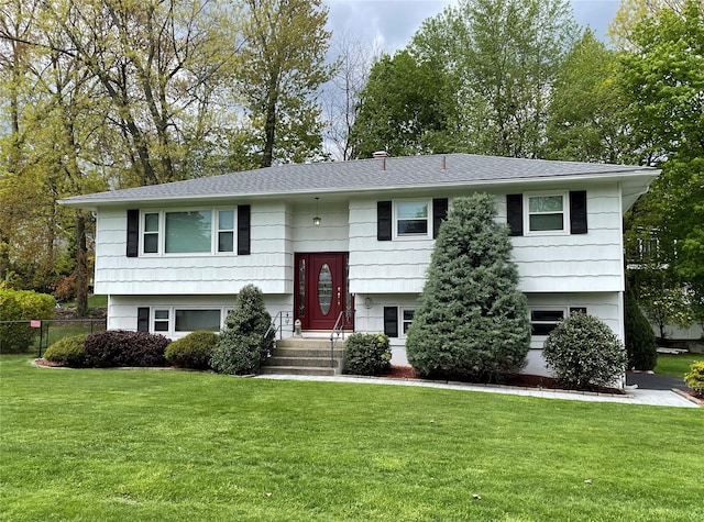 raised ranch with a front lawn