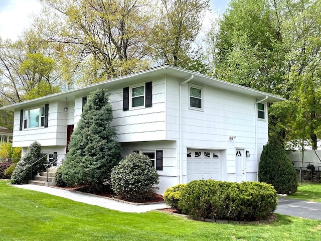 view of front facade with a front yard and a garage