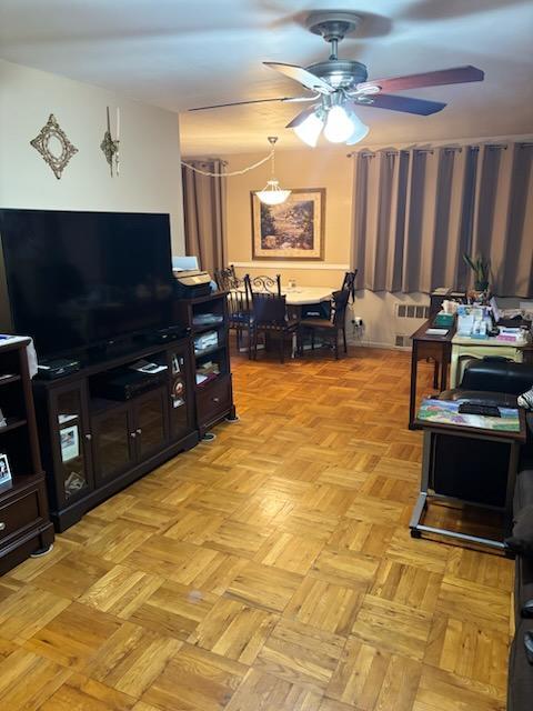 living area featuring a ceiling fan