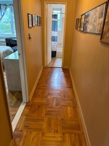 hall featuring baseboards
