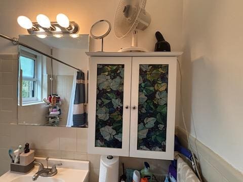 full bathroom with a sink
