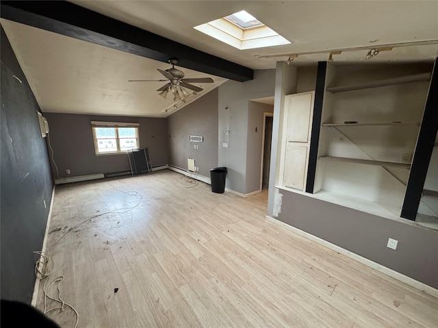 unfurnished living room with ceiling fan, light wood-type flooring, and lofted ceiling with skylight