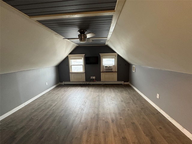 additional living space featuring cooling unit, dark hardwood / wood-style floors, ceiling fan, and lofted ceiling