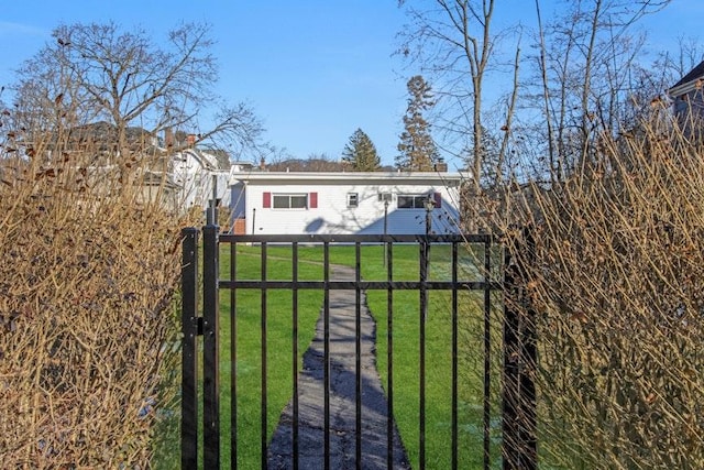 view of gate featuring a lawn