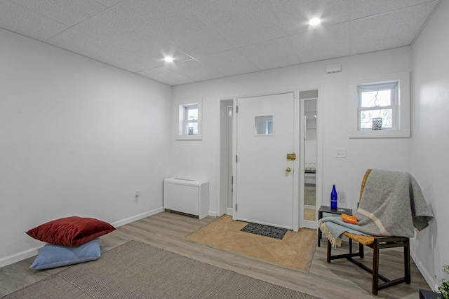 foyer featuring a paneled ceiling and light hardwood / wood-style flooring