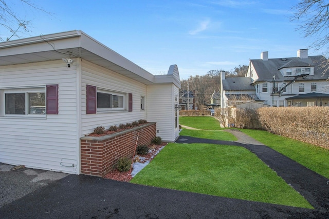 view of side of home featuring a lawn