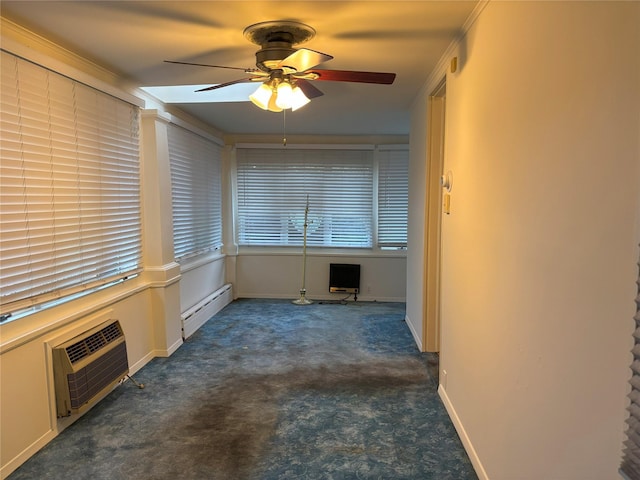 interior space featuring a baseboard heating unit, carpet flooring, a wall unit AC, a ceiling fan, and baseboards