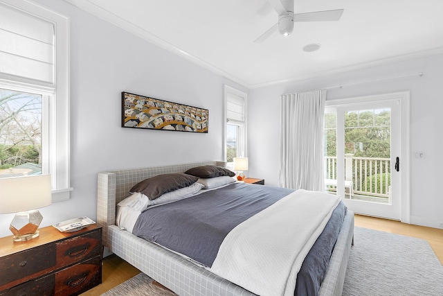 bedroom featuring ceiling fan, wood-type flooring, ornamental molding, and access to outside