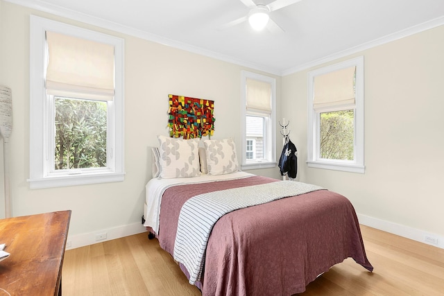 bedroom with ceiling fan, light wood-type flooring, and crown molding