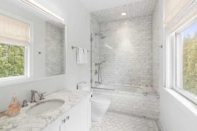 full bathroom with tile patterned floors, vanity, toilet, and tiled shower / bath combo