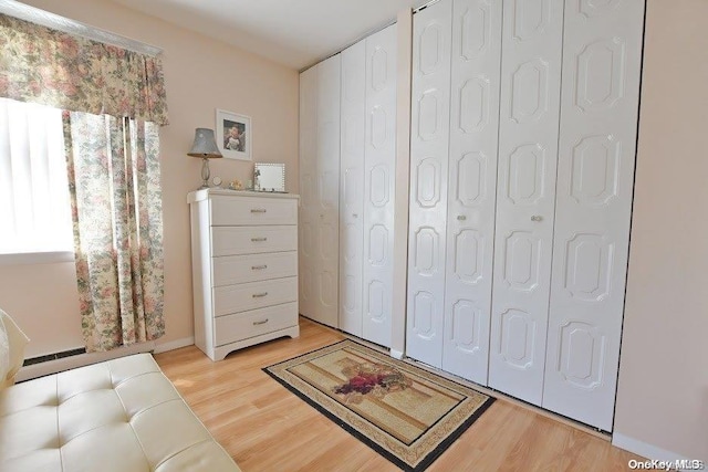 living area with plenty of natural light and light hardwood / wood-style flooring