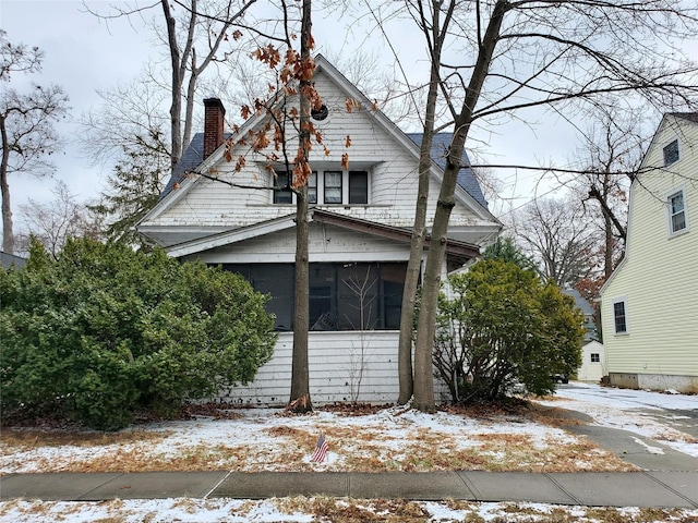 snow covered property with a sunroom