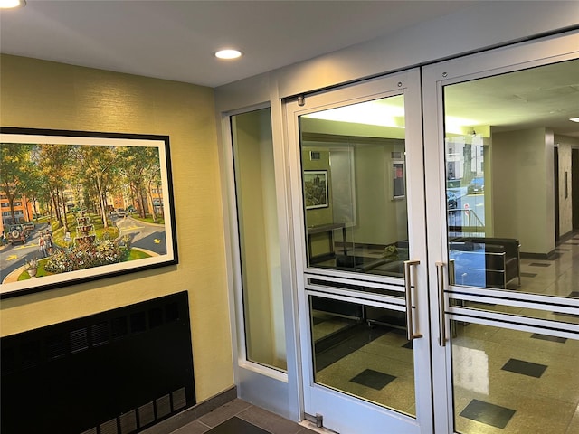 doorway to outside with radiator and dark tile patterned floors