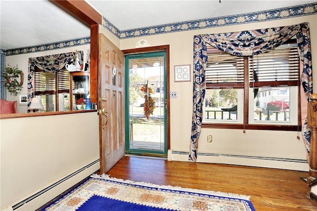 entryway with hardwood / wood-style flooring and baseboard heating