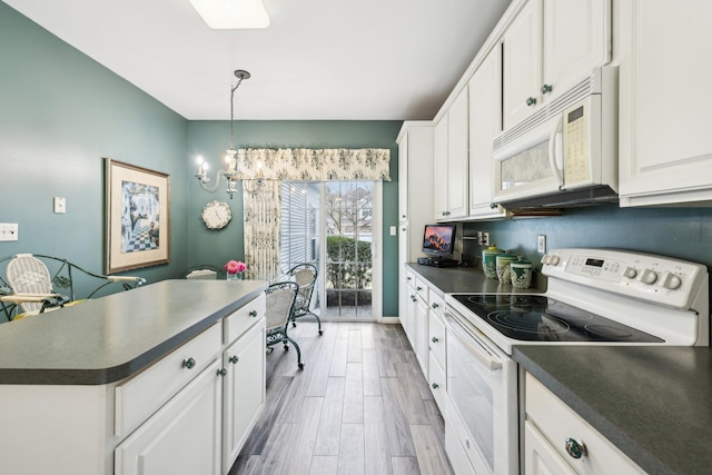 kitchen featuring white cabinetry, a notable chandelier, white appliances, wood-type flooring, and pendant lighting