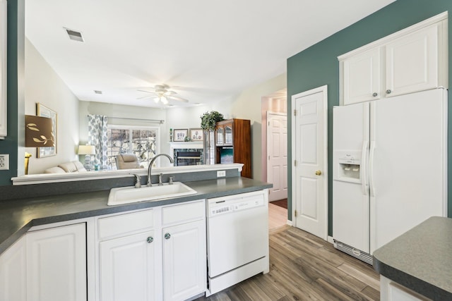 kitchen featuring ceiling fan, sink, white cabinets, and white appliances