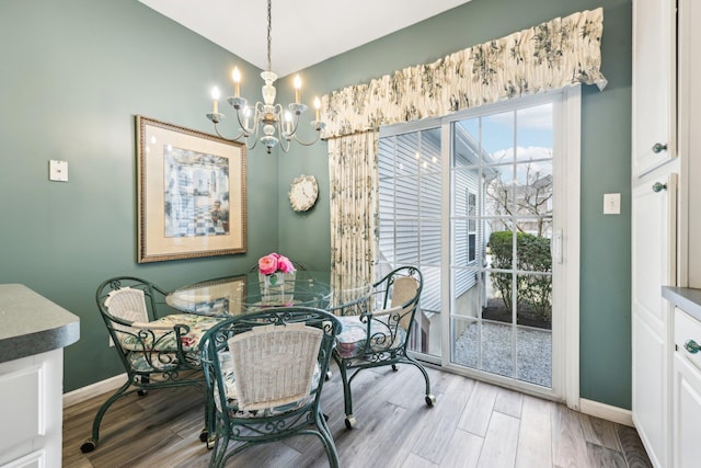 dining room featuring a notable chandelier and light hardwood / wood-style floors