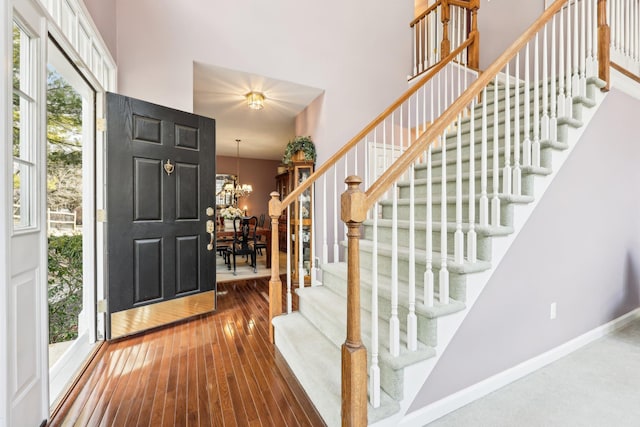 foyer entrance featuring hardwood / wood-style flooring and a chandelier