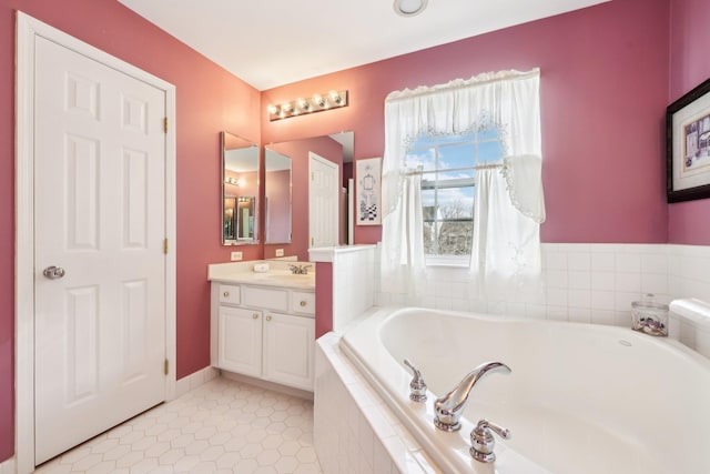 bathroom featuring tiled bath, tile patterned floors, and vanity