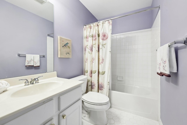 full bathroom featuring toilet, tile patterned flooring, vanity, and shower / bath combo with shower curtain