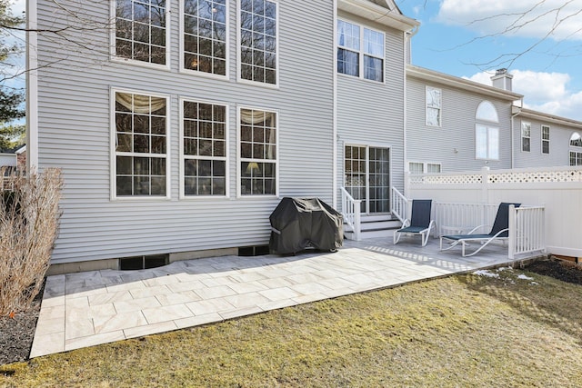 rear view of house featuring a lawn and a patio area