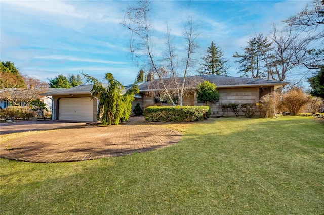 single story home with a garage and a front yard