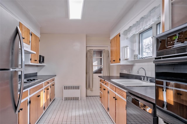 kitchen featuring tasteful backsplash, black appliances, sink, light tile patterned flooring, and radiator heating unit