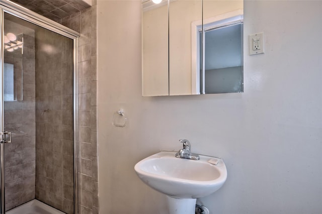 bathroom with sink and an enclosed shower