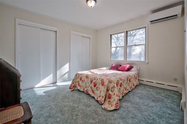 carpeted bedroom featuring a baseboard radiator, two closets, and a wall mounted air conditioner