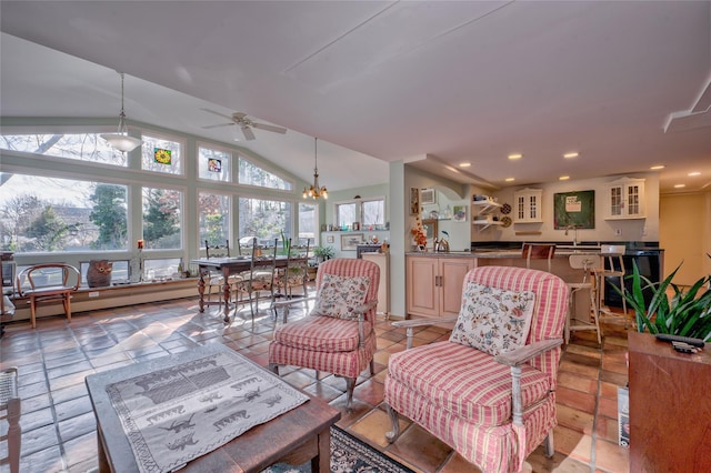 sunroom with vaulted ceiling, a wealth of natural light, ceiling fan with notable chandelier, and a baseboard radiator