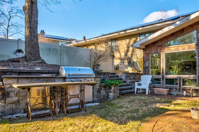 view of patio with an outdoor kitchen and area for grilling