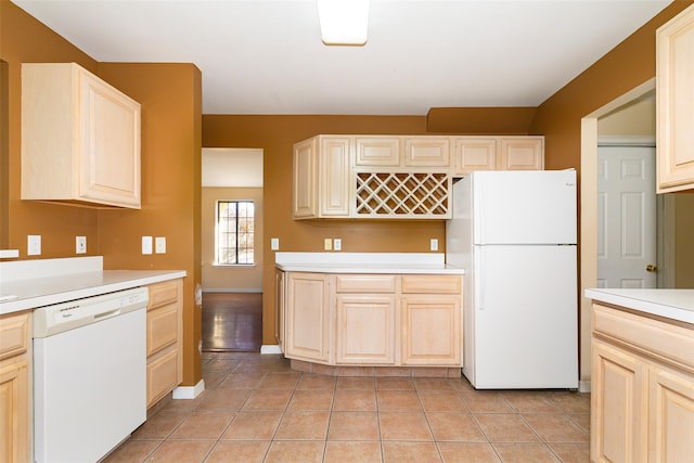 kitchen featuring light tile patterned floors and white appliances