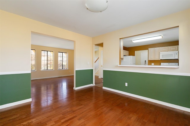 spare room featuring dark hardwood / wood-style floors