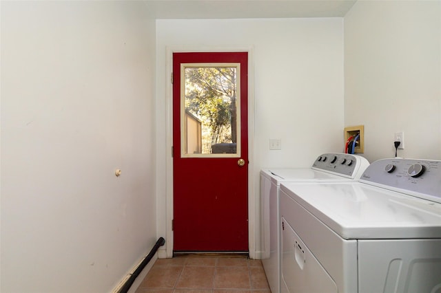 laundry area with light tile patterned floors and separate washer and dryer