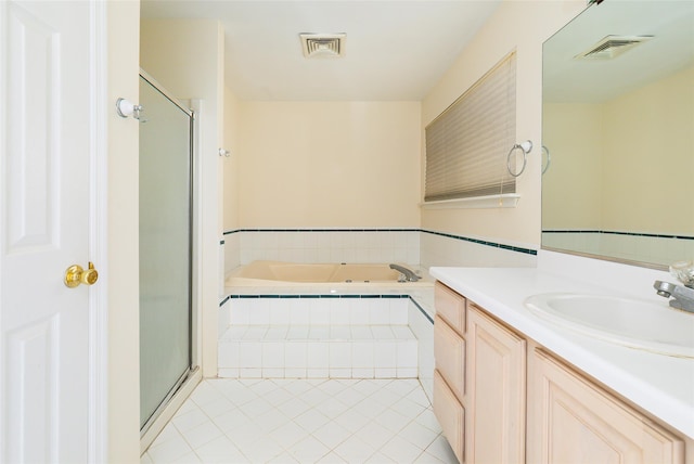 bathroom with plus walk in shower, vanity, and tile patterned floors