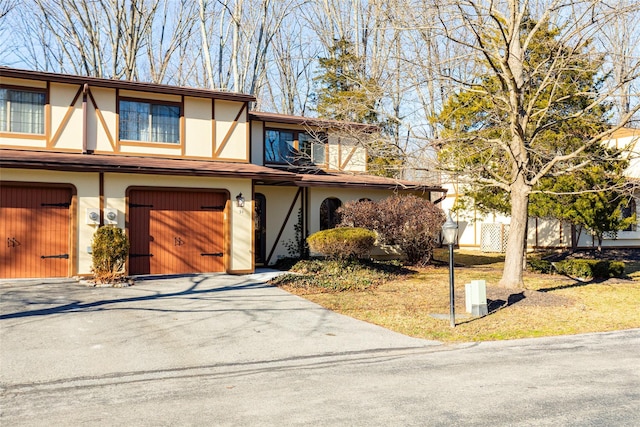 tudor-style house featuring a garage