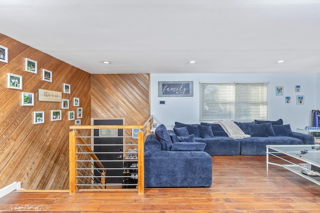 living room featuring wood-type flooring and wood walls