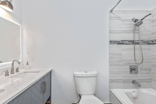 full bathroom with toilet, tiled shower / bath combo, and vanity