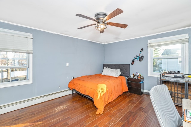 bedroom featuring ceiling fan, a baseboard heating unit, dark hardwood / wood-style flooring, and ornamental molding