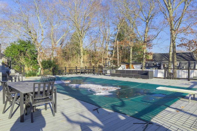 view of pool with a diving board