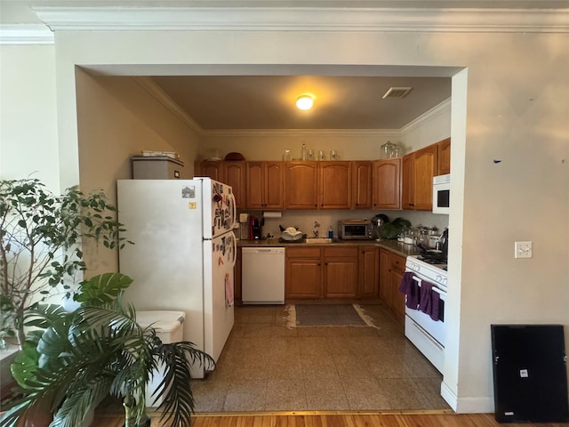 kitchen featuring white appliances, ornamental molding, and sink