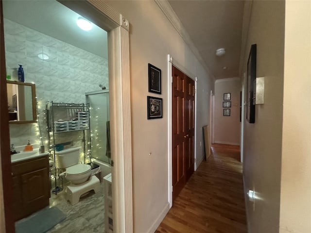 corridor with ornamental molding and dark hardwood / wood-style flooring