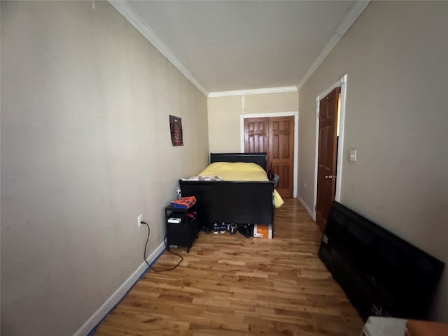 bedroom with ornamental molding and wood-type flooring