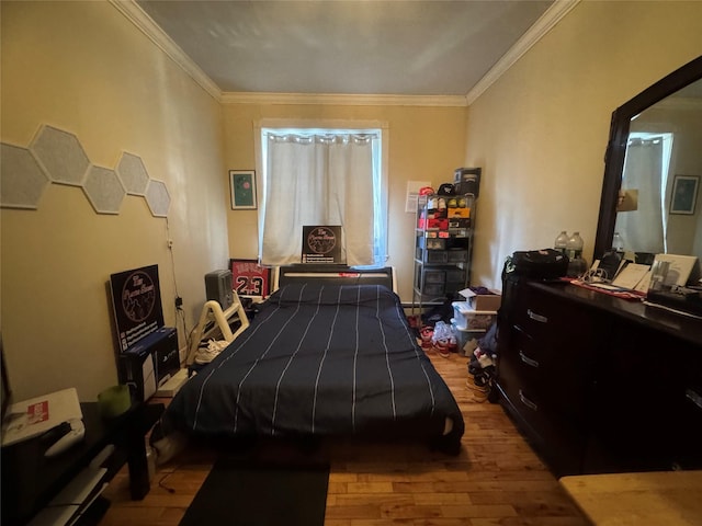 bedroom with light hardwood / wood-style floors and crown molding