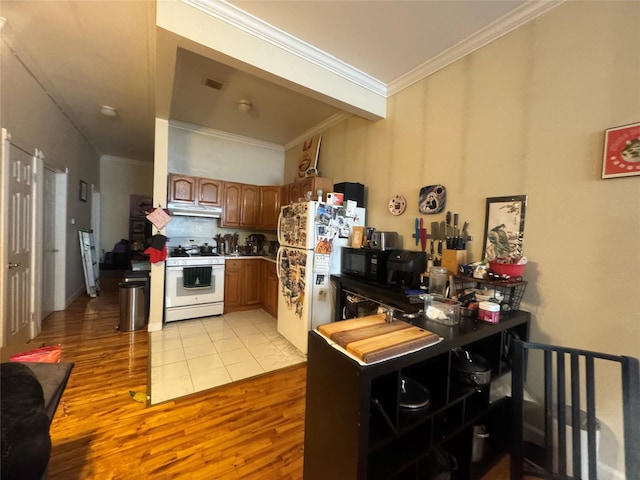 kitchen featuring white appliances, ornamental molding, and light hardwood / wood-style flooring