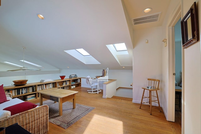 interior space with lofted ceiling, light hardwood / wood-style floors, and ceiling fan