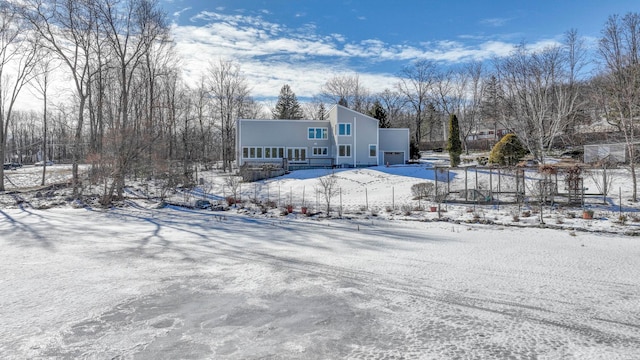 view of snow covered rear of property