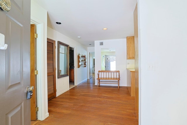 corridor with hardwood / wood-style floors