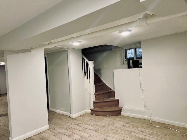 basement with light hardwood / wood-style flooring